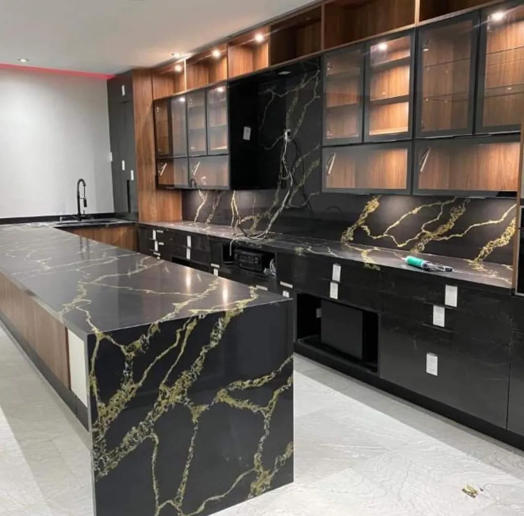 Modern gourmet kitchen with sleek black and gold marble countertops.
