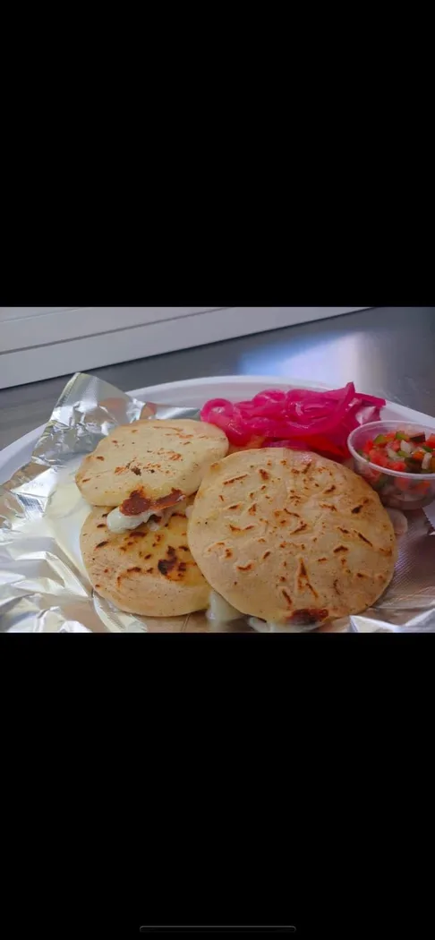 Pupusas served with pickled onions and salsa at Jerusalen Restaurante.