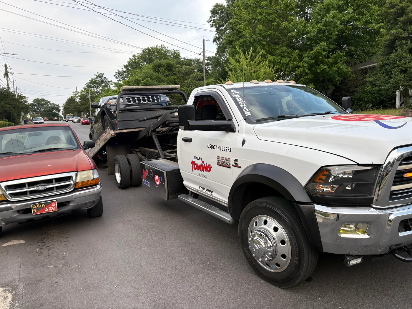 Omar's Towing service in Raleigh, North Carolina, loading vehicle.