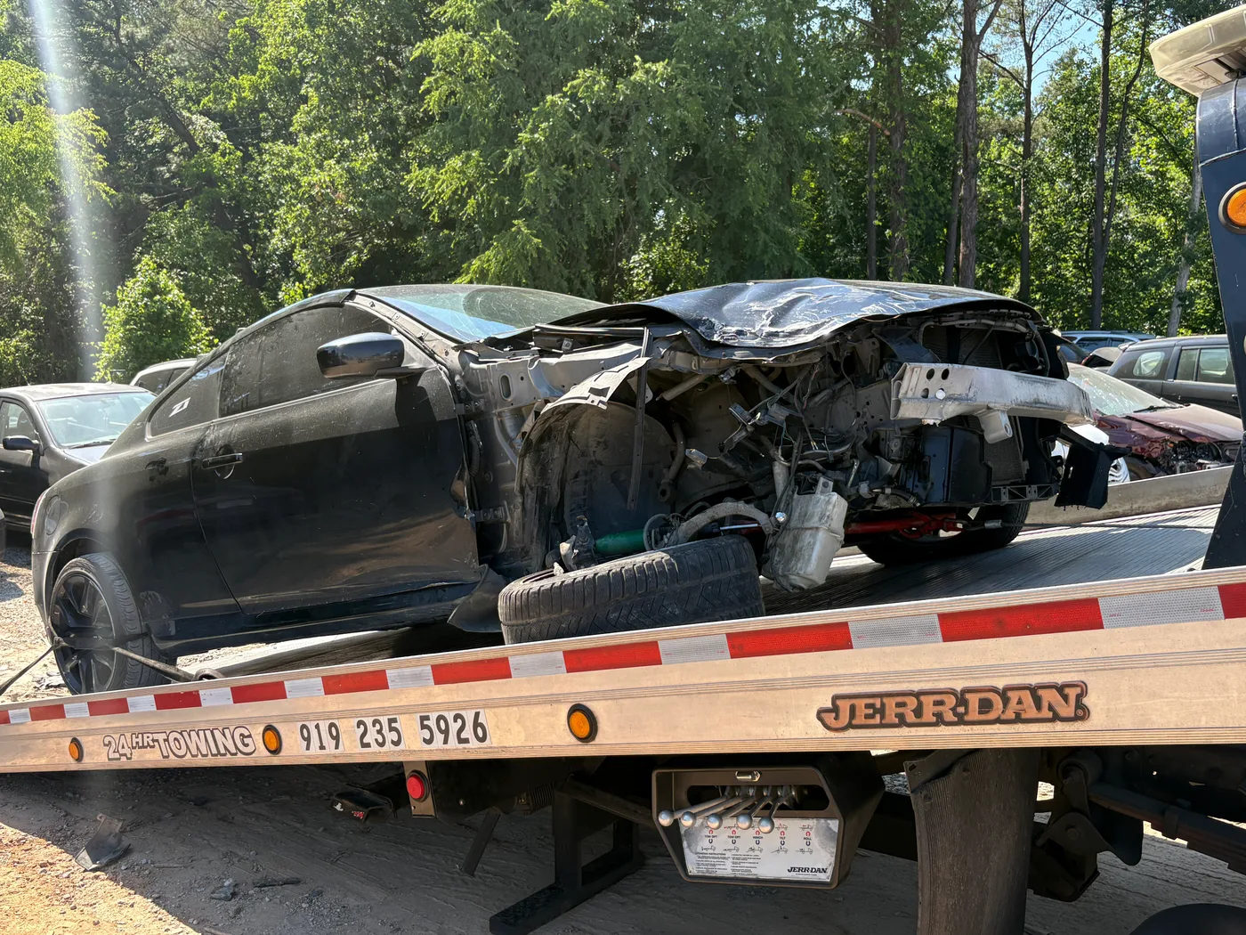 Towed damaged car on truck in Raleigh, North Carolina.
