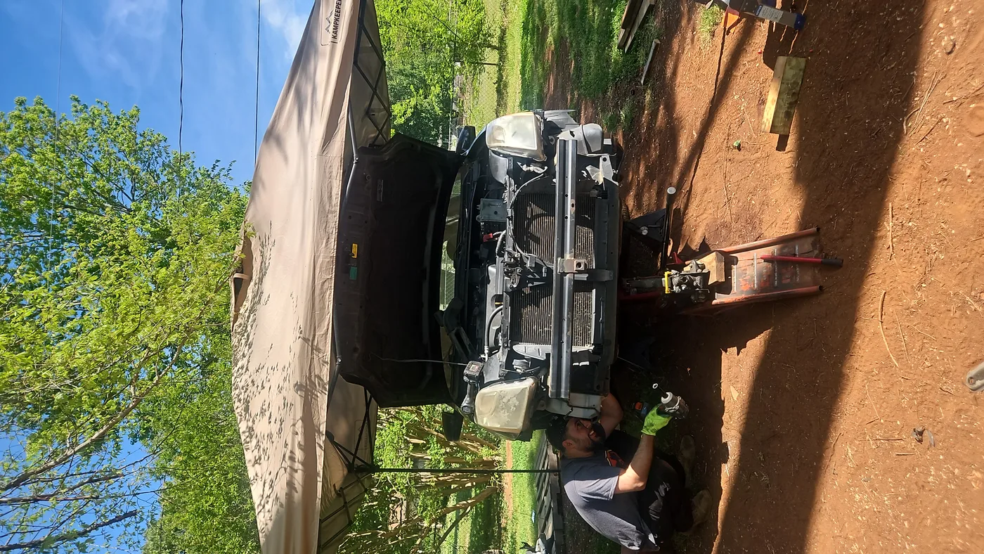 Mobile mechanic servicing a car outdoors in Concord, North Carolina.